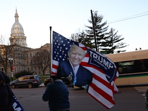 caption: Supporters of then-President Donald Trump gather outside the Michigan State Capitol in 2020.