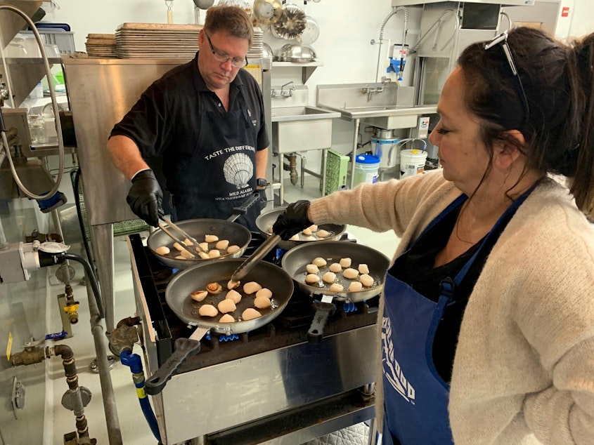 caption: Tacoma-based seafood company owners Jim and Mona Stone prepare scallops to serve to taste testers at the OSU Food Innovation Center in Portland.