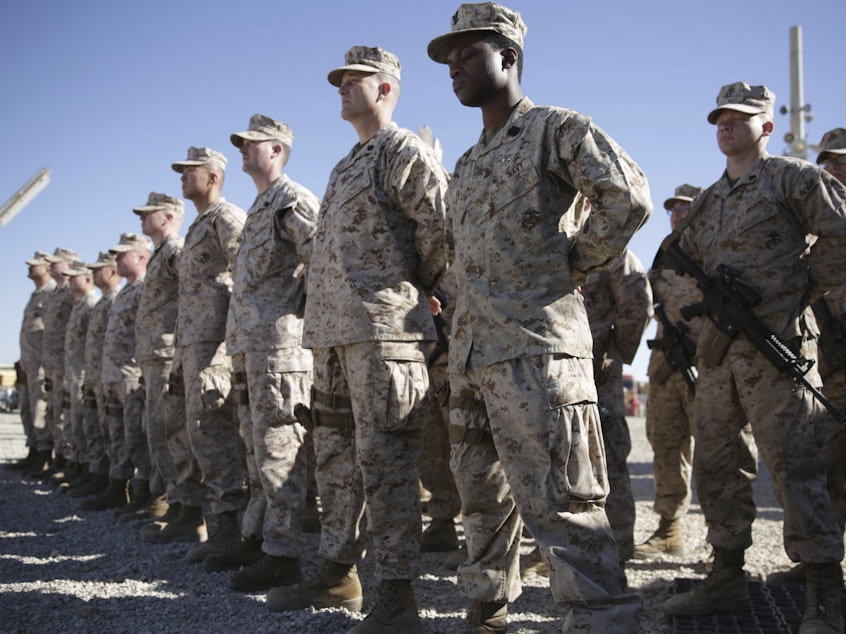 caption: U.S. Marines stand guard during the change of command ceremony at Shorab military camp in Afghanistan's Helmand province in January 2018.