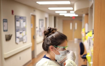 caption: Nurses in the intensive care unit of MedStar St. Mary's Hospital check the fit of protective equipment before entering a patient's room March 24, 2020 in Leonardtown, Maryland. (Win McNamee/Getty Images)