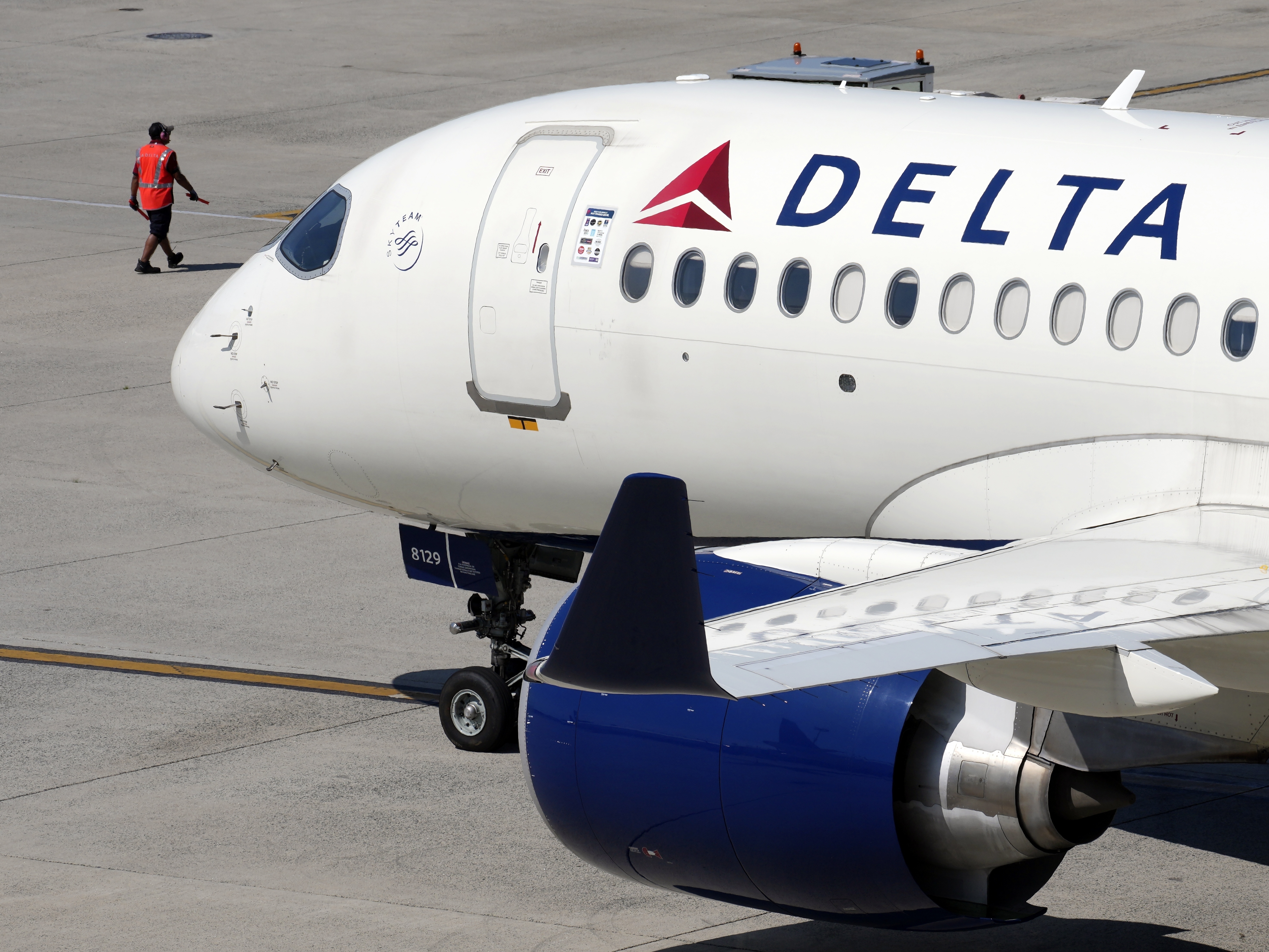 caption: Some airline issues continued Monday after a faulty software update caused technological havoc worldwide and resulted in several carriers grounding flights, but the number of flights impacted is declining. Here, a Delta Air Lines jet leaves the gate on Friday, July 19, 2024, at Logan International Airport in Boston.