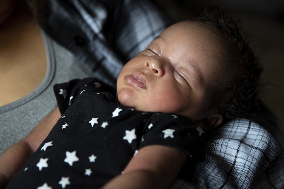 caption: Deita McChristian holds her son Alfred, born at the end of September, on Tuesday, October 17, 2023, at her apartment in Tacoma.