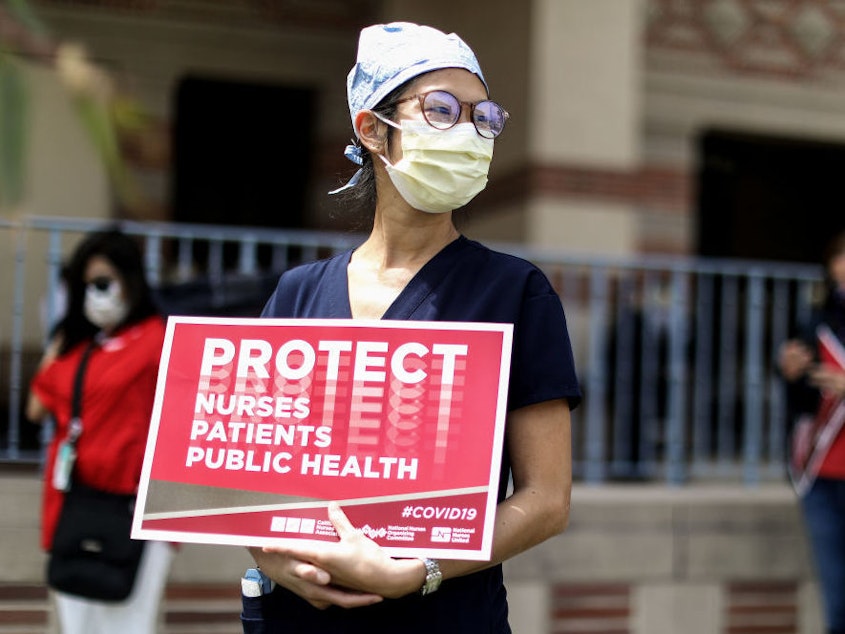 caption: Registered nurses and healthcare workers at UCLA Medical Center in Santa Monica, Calif., protested in April what they said was a lack of personal protective equipment for the pandemic's front line workers.