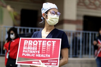 caption: Registered nurses and healthcare workers at UCLA Medical Center in Santa Monica, Calif., protested in April what they said was a lack of personal protective equipment for the pandemic's front line workers.