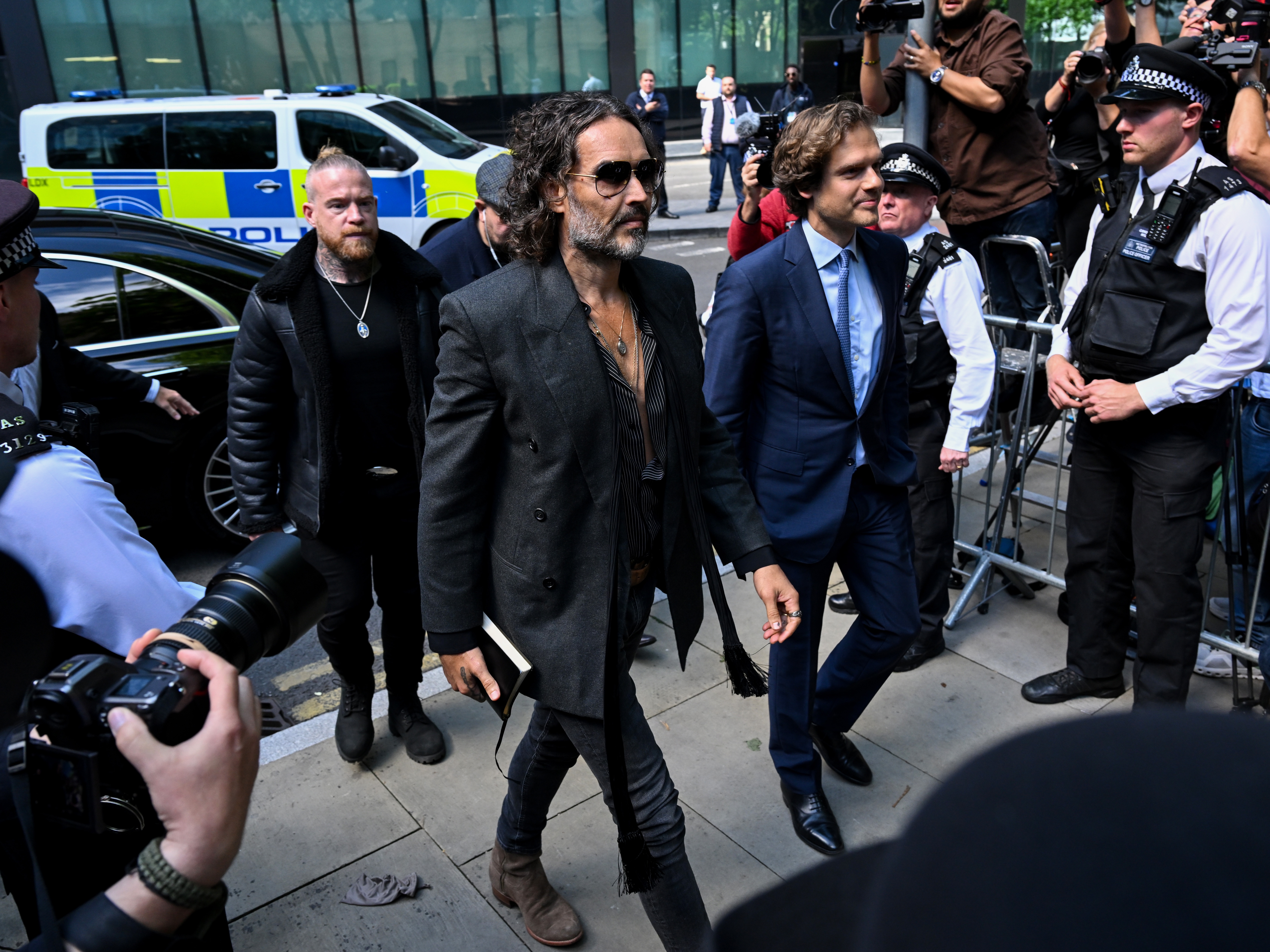 caption: Russell Brand arrives at Southwark Crown Court on Friday in London.