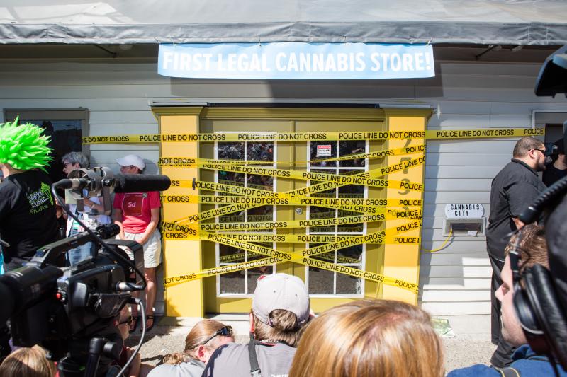 caption: Cannabis City, Seattle's first recreational marijuana store, used police tape for their tongue-in-cheek ribbon-cutting.