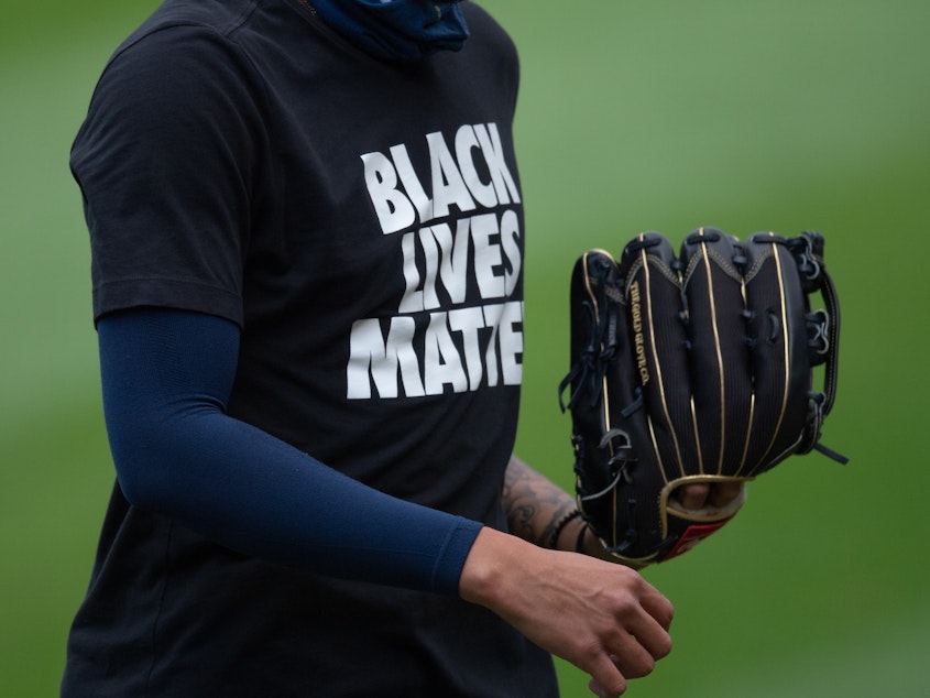 caption: CHICAGO, IL - AUGUST 05: A Milwaukee Brewers player wears a Black Lives Matter shirt during warmups before the MLB game between the Chicago White Sox and the Milwaukee Brewers on August 05, 2020 at Guaranteed Rate Field in Chicago, Illinois.