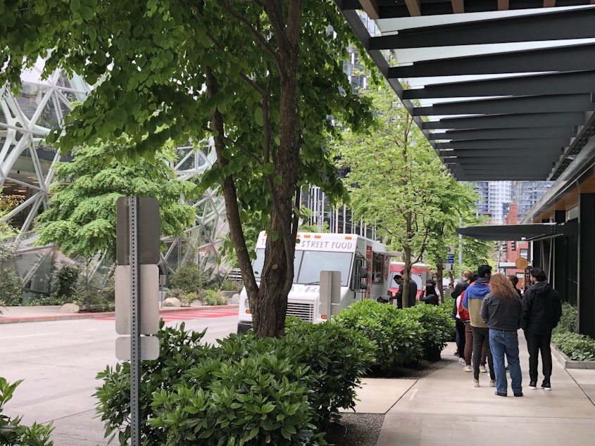 caption: Workers line up for lunch at South Lake Union in downtown Seattle.