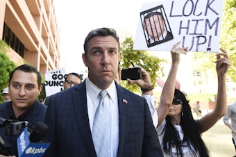 caption: Rep. Duncan Hunter, R-Calif.,  leaves federal court after a hearing in San Diego in July.