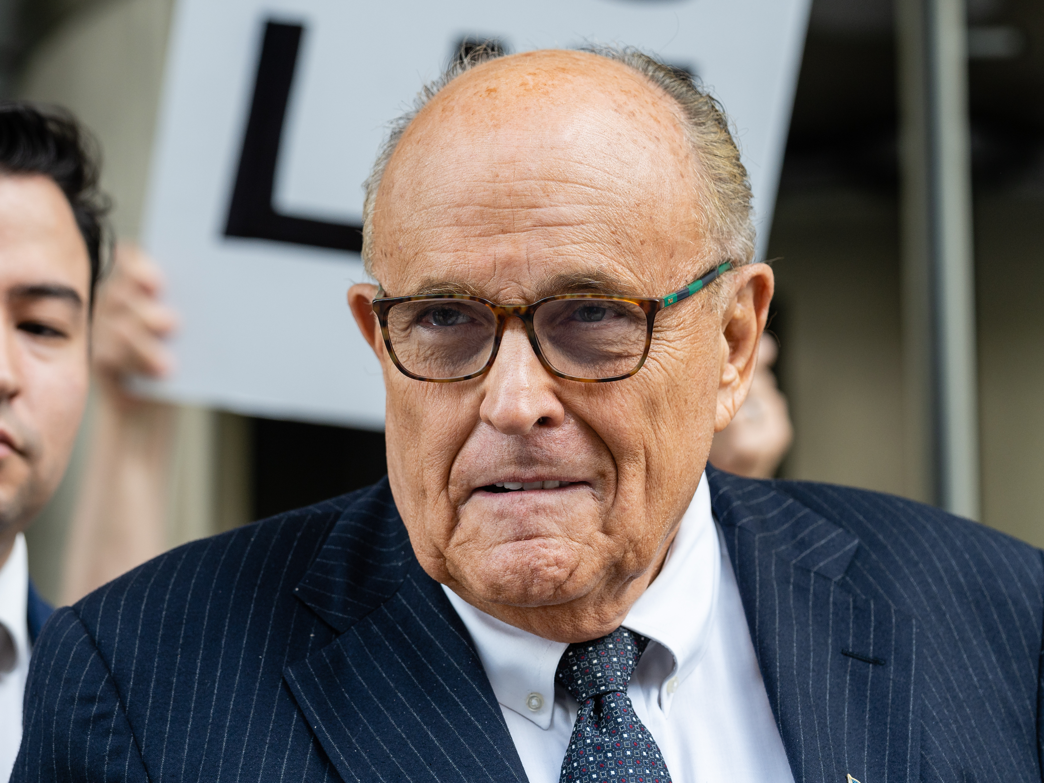 caption: Rudy Giuliani, former lawyer to Donald Trump, exits federal court in Washington, D.C., on May 19.