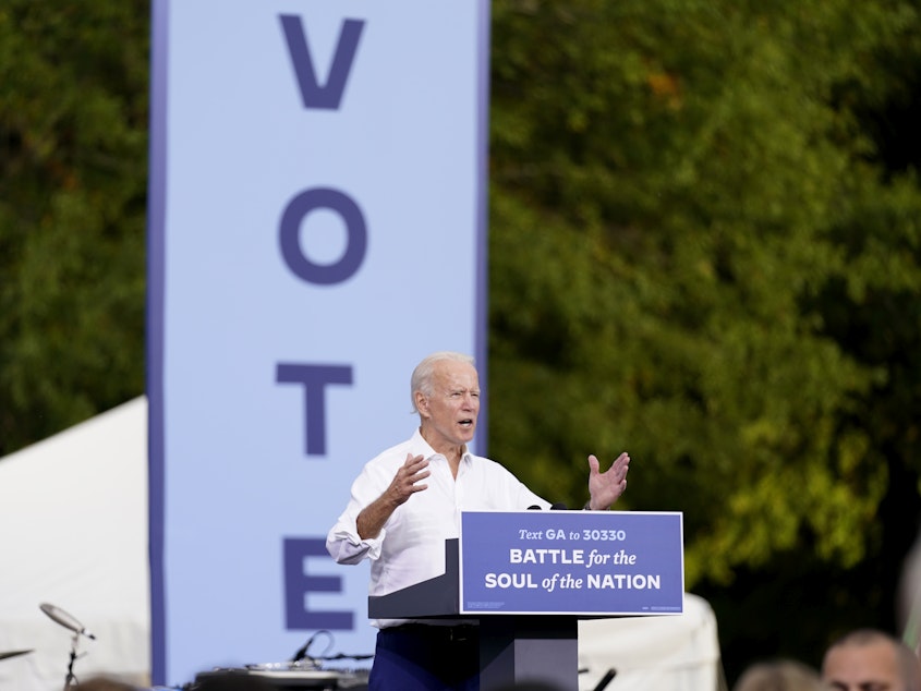 caption: President-elect Joe Biden speaks at a drive-in rally at Cellairis Amphitheatre in Atlanta on Oct. 27. Biden is the first Democratic presidential nominee to win Georgia since 1992.