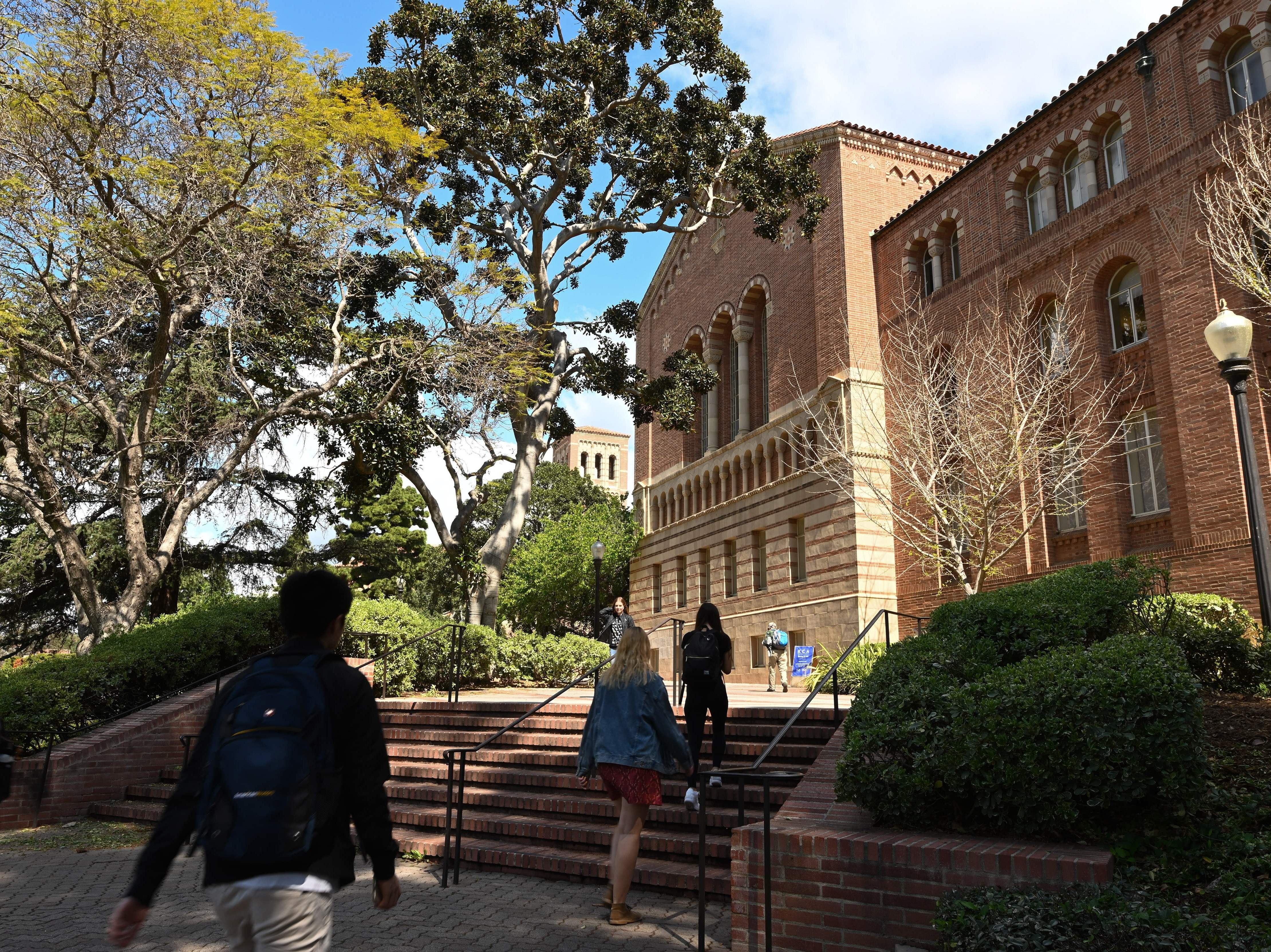 caption: Students walk on the campus of University of California at Los Angeles (UCLA) in Los Angeles in March 2020.