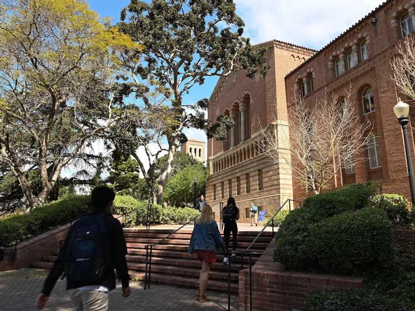 caption: Students walk on the campus of University of California at Los Angeles (UCLA) in Los Angeles in March 2020.