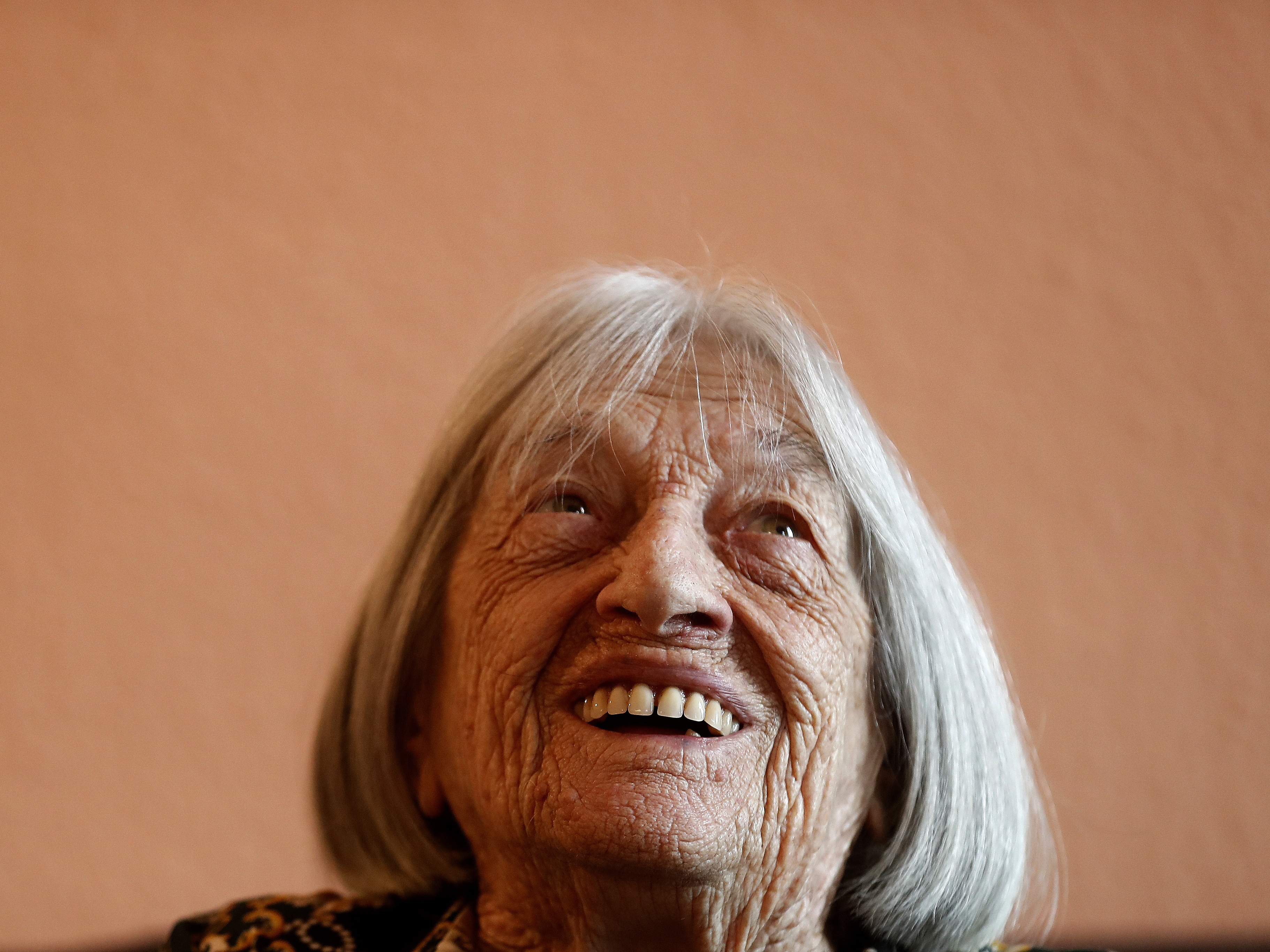 caption: Agnes Keleti, former Olympic gold medal winning gymnast, smiles at her apartment in Budapest, Hungary, on Jan. 8, 2020.