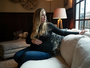 caption: Lauren Miller at her home in Dallas, Texas, in January 2023. When she was 15 weeks pregnant, she traveled to Colorado to have a "selective reduction" abortion, after one of her twins was diagnosed with a fatal condition.