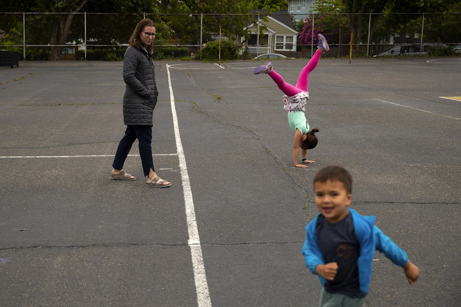 caption: Kadie Bell Sata’s two youngest children play on the Greenlake Elementary playground after school on Monday, June 3, 2024, in Seattle. 