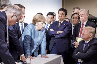 caption: Germany's Chancellor Angela Merkel (center) speaks with President Trump during the Group of Seven summit in La Malbaie, Quebec, Canada, on June 9. The Trump administration has surprised and frustrated allies in areas including trade, security, human rights and the environment.