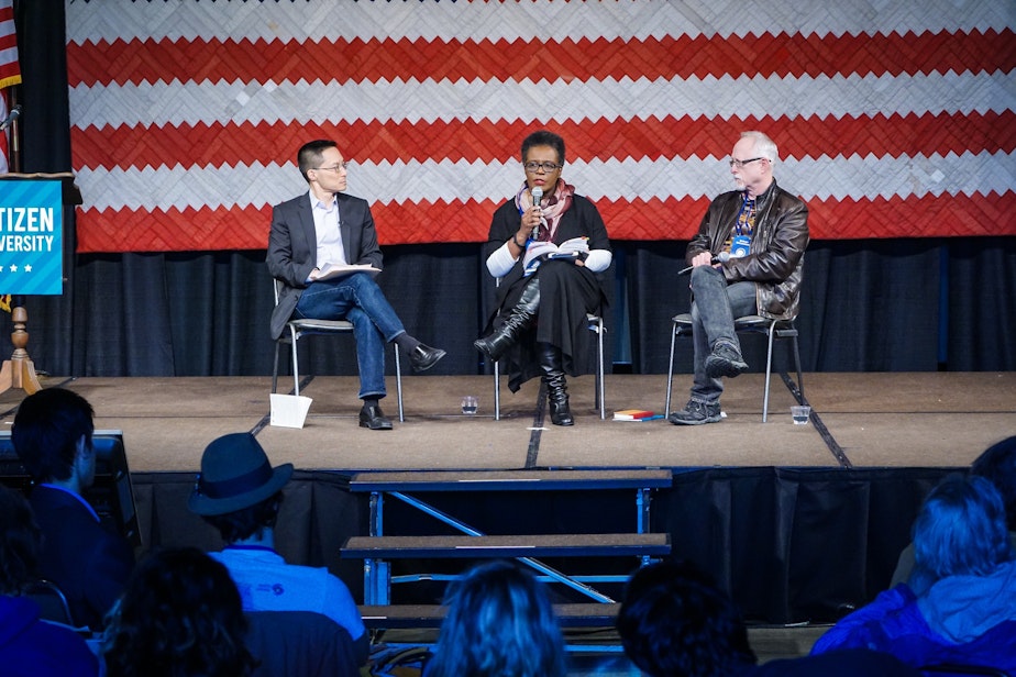 caption: Poet Claudia Rankine (center) speaks with moderator Eric Liu (left) and playwright, Robert Schenkkan at the Citizen University National Confernence at the Seattle Center in March.
