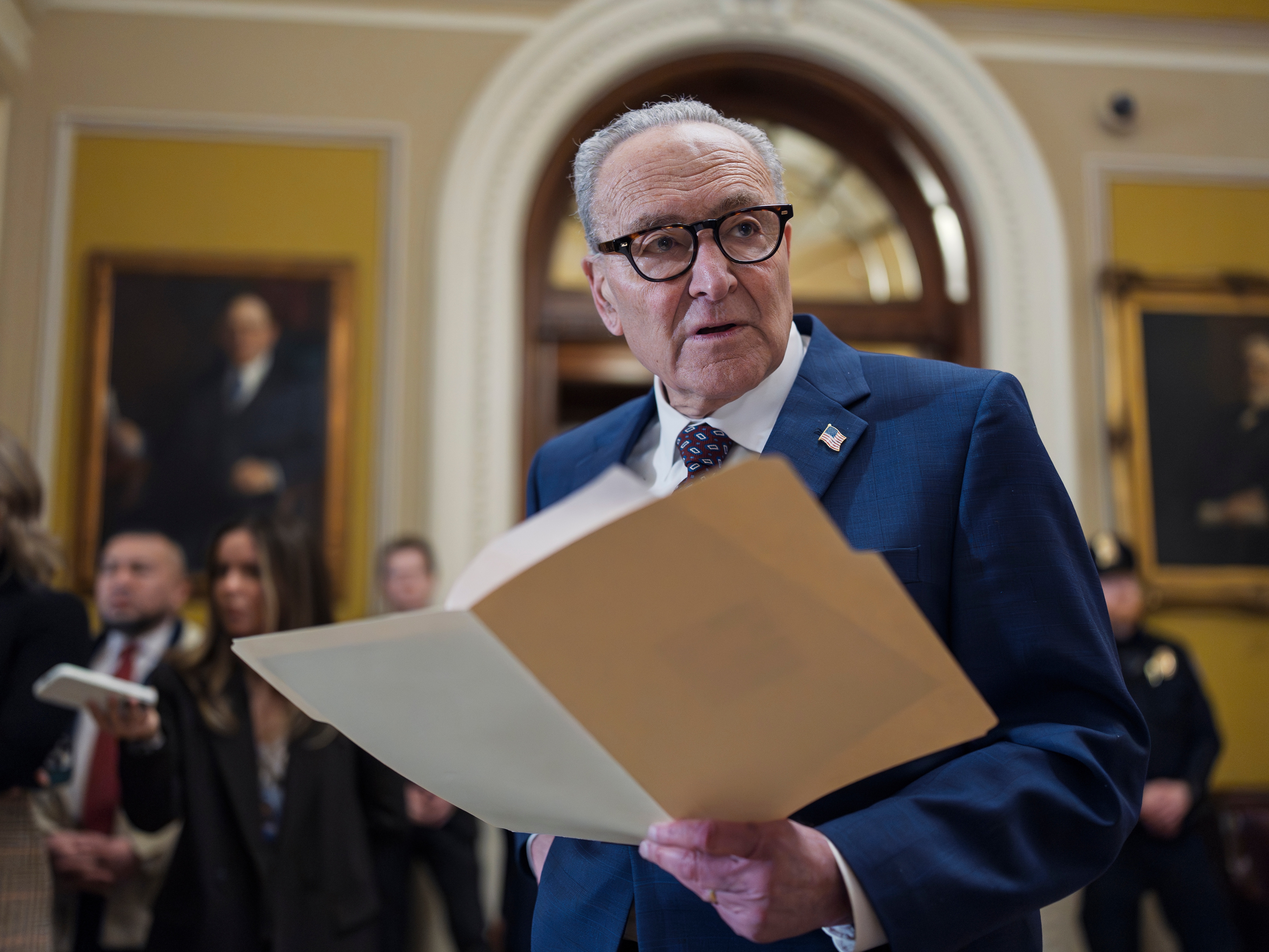 caption: Senate Minority Leader Chuck Schumer, D-N.Y., waits to speak to reporters following a closed-door meeting with fellow Democrats on Wednesday.