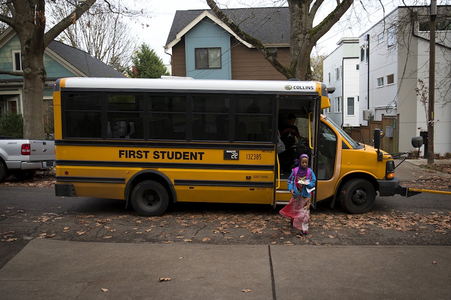 caption: Biftu Aliya, 9, gets off of the school bus on Thursday, November 15, 2018, at her home in Seattle. 