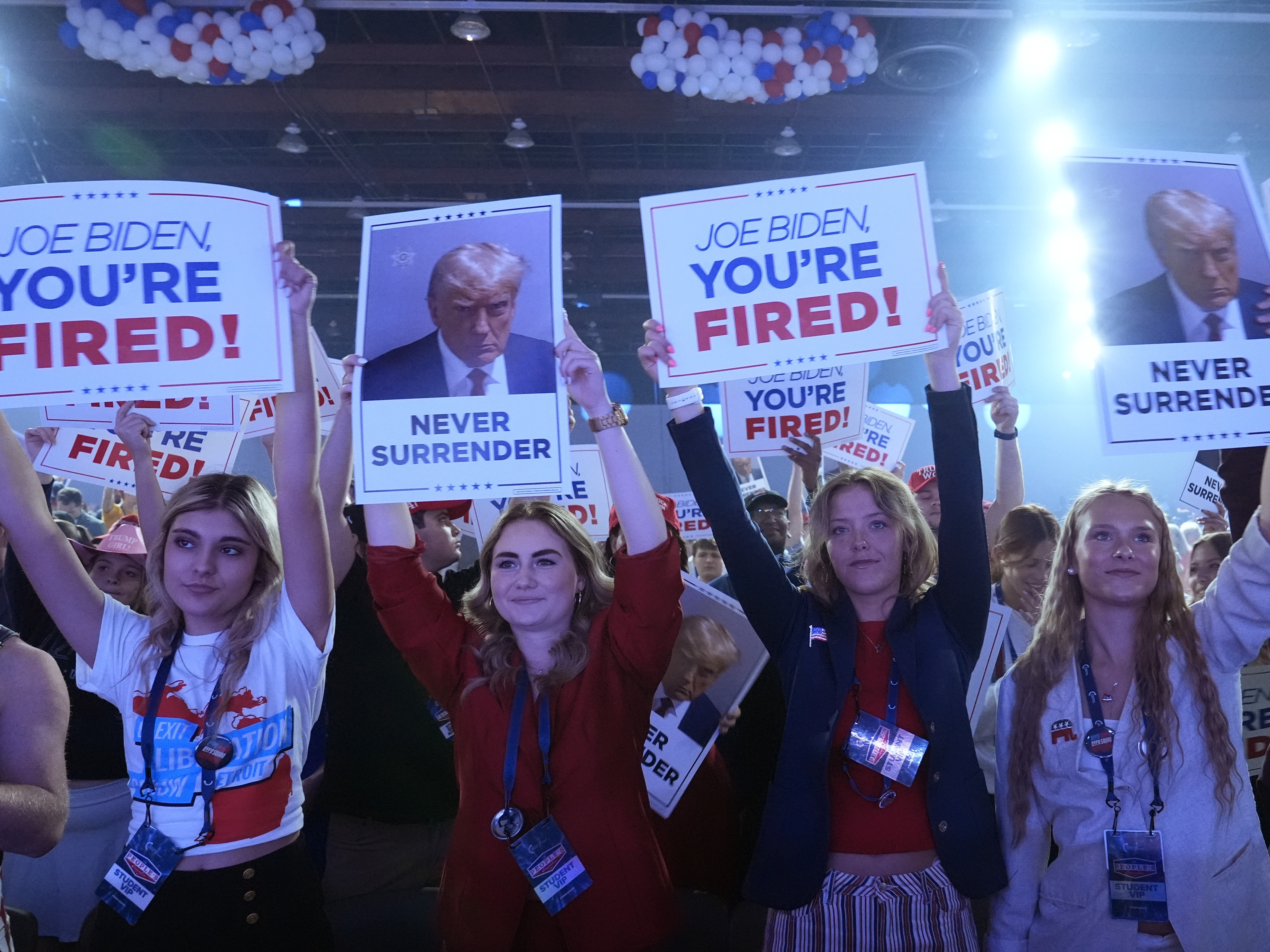 caption: People arrive before Republican presidential candidate former President Donald Trump speaks at the "People's Convention" of Turning Point Action Saturday in Detroit.