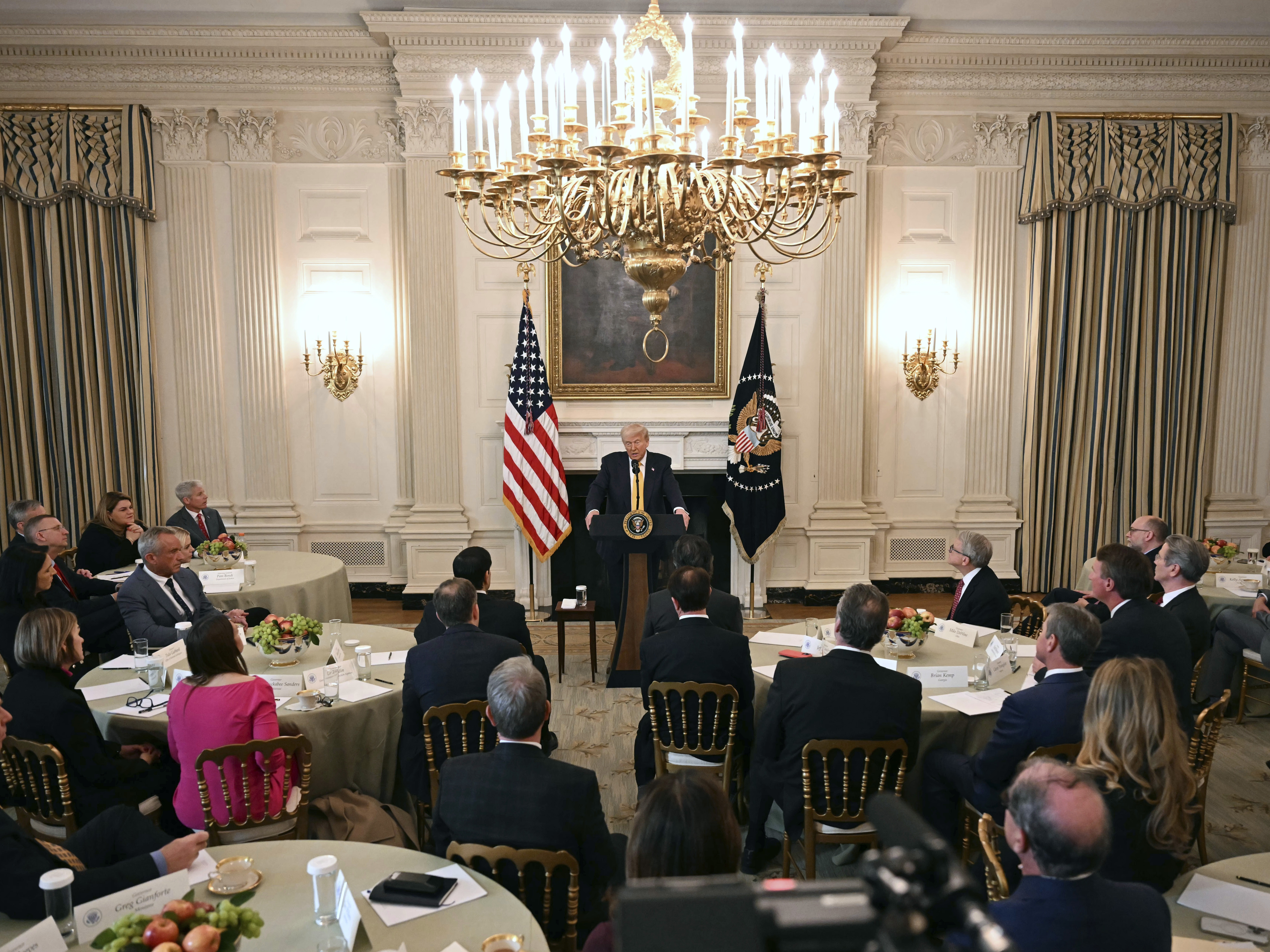 caption: President Trump speaks with governors in the White House last week. He challenged Maine Gov. Janet Mills about her state's policy on transgender student athletes, prompting her to answer, "See you in court."