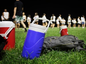 caption: Marching bands are getting creative to beat the heat of climate change. Some changes include covering brass instruments under direct sunlight, scheduling frequent water breaks and time to put on extra sunscreen, no longer wearing traditional marching band uniforms at games and practicing before sunrise or after sunset.