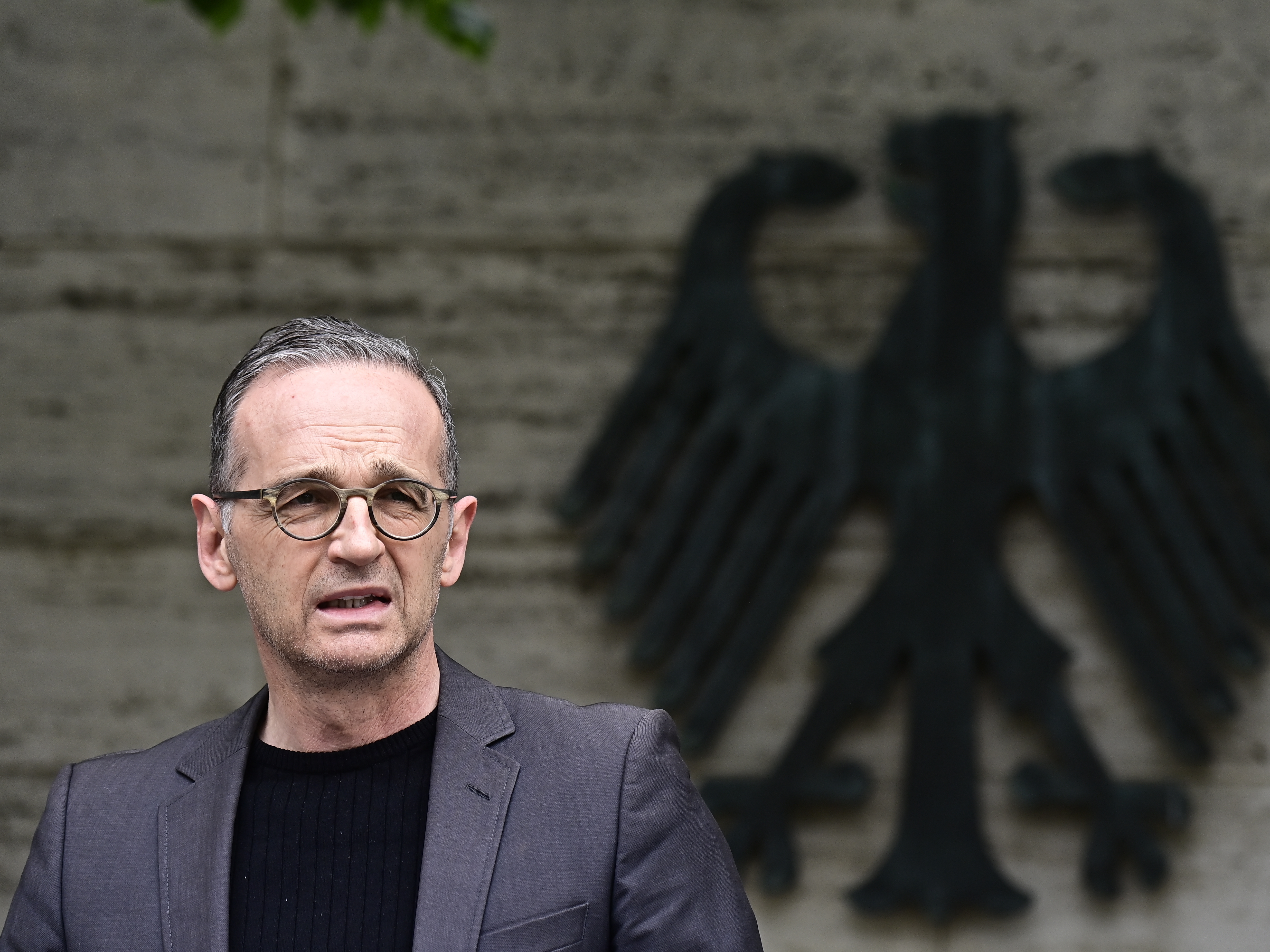 caption: German Foreign Minister Heiko Maas addresses the media Friday in Berlin. Germany has reached an agreement with Namibia that will see it officially recognize as genocide the colonial-era killings of tens of thousands of people and commit to spending $1.3 billion, largely on development projects.