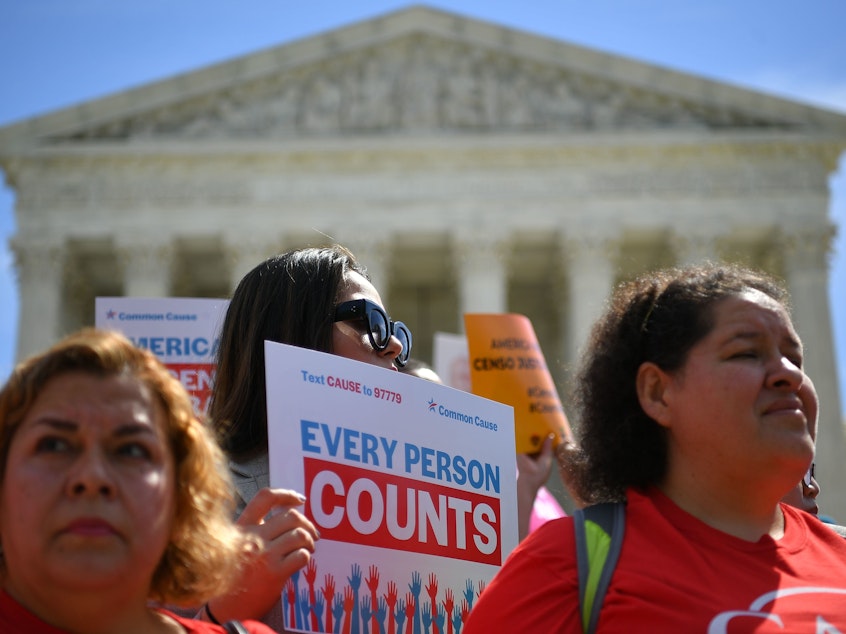 caption: Demonstrators rally outside the U.S. Supreme Court in April to protest against the Trump administration's efforts to add a citizenship question to the 2020 census.