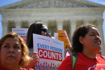 caption: Demonstrators rally outside the U.S. Supreme Court in April to protest against the Trump administration's efforts to add a citizenship question to the 2020 census.