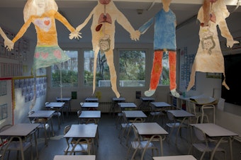 caption: An empty classroom during the pandemic in a school in Madrid.