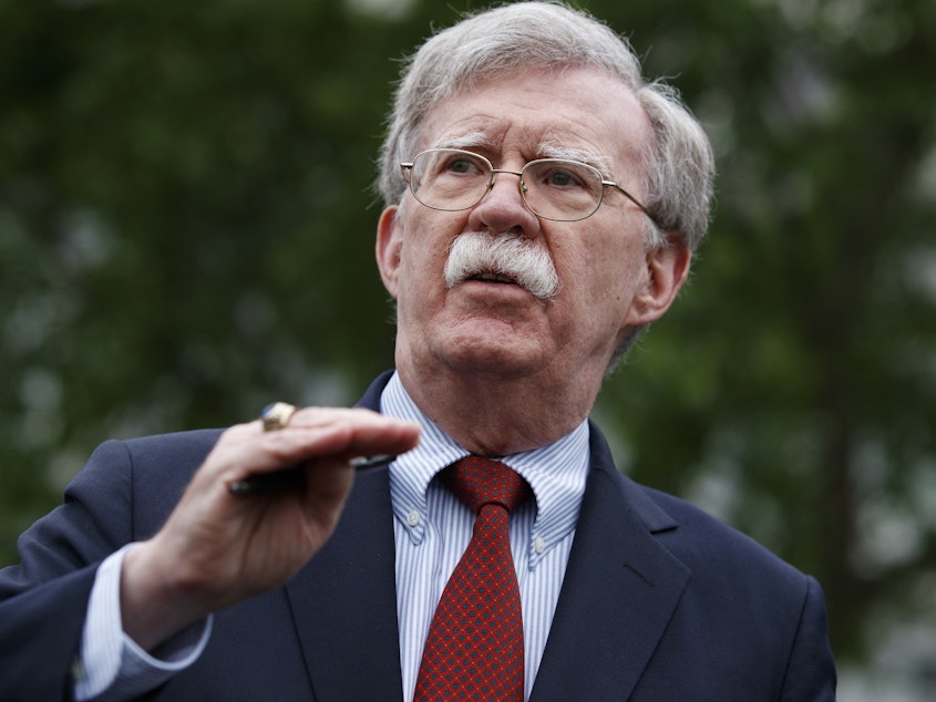 caption: National security adviser John Bolton talked to reporters outside the White House. The hawkish former U.N. ambassador is stepping down.