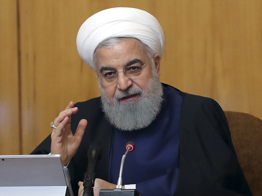 caption: Iranian President Hassan Rouhani says Iran will begin keeping its excess uranium and heavy water, and he set a 60-day deadline for new terms to its nuclear deal or the country will resume higher uranium enrichment. Rouhani is seen here at a cabinet meeting in Tehran on Wednesday.