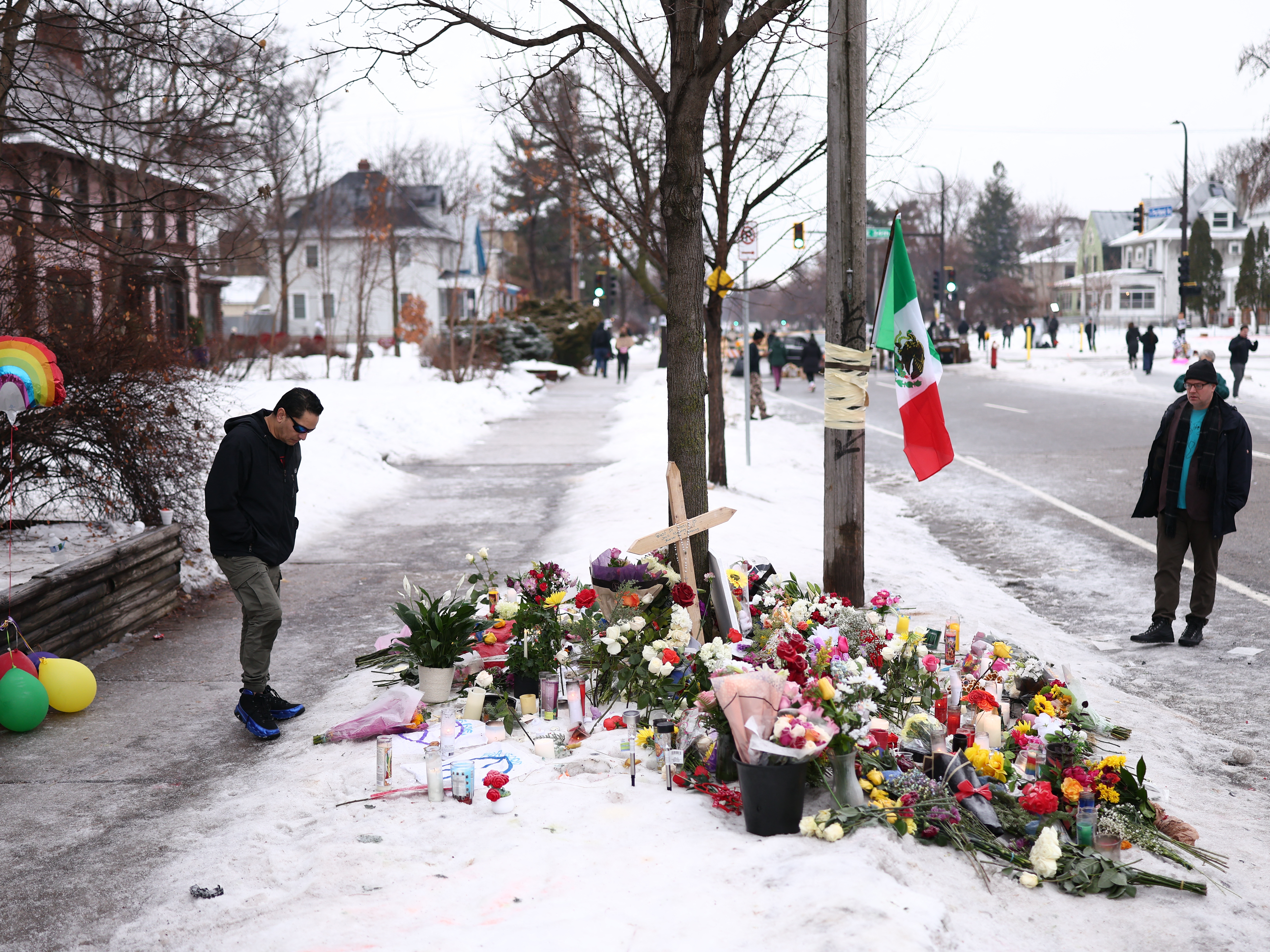 caption: People gather at a makeshift memorial for Renee Nicole Good, 37, who was shot and killed at  on Wednesday by an ICE officer as she apparently tried to drive away from a group of ICE officers in Minneapolis, Minn.