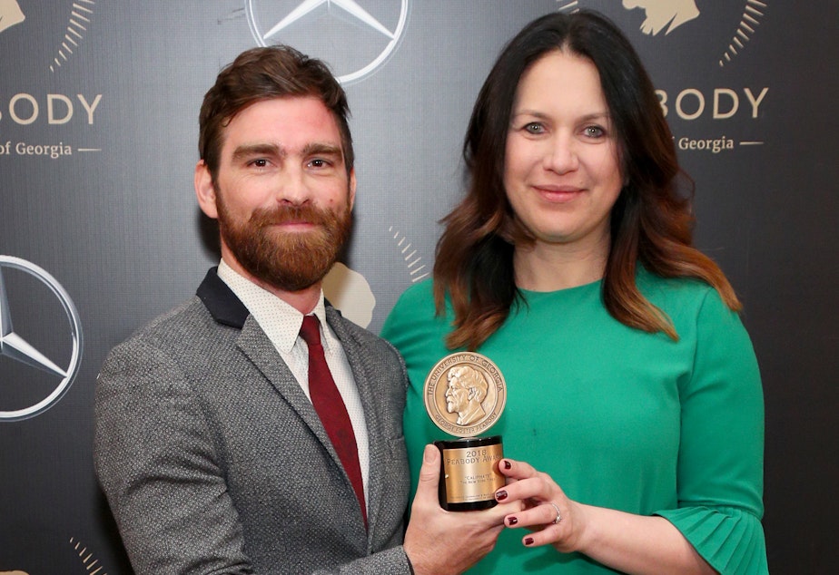 caption: Rukmini Callimachi and colleague Andy Mills pose with their Peabody Award for 'Caliphate' at the 78th Annual Peabody Awards Ceremony in May 2019.