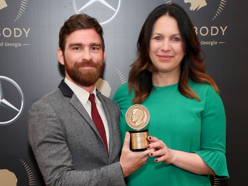 caption: Rukmini Callimachi and colleague Andy Mills pose with their Peabody Award for 'Caliphate' at the 78th Annual Peabody Awards Ceremony in May 2019.