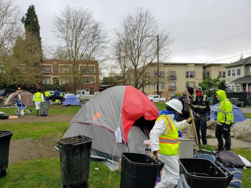 caption: Seattle Parks crews remove tents and debris at a homeless encampment in Seven Hills Park on Thursday, February 17, 2022.