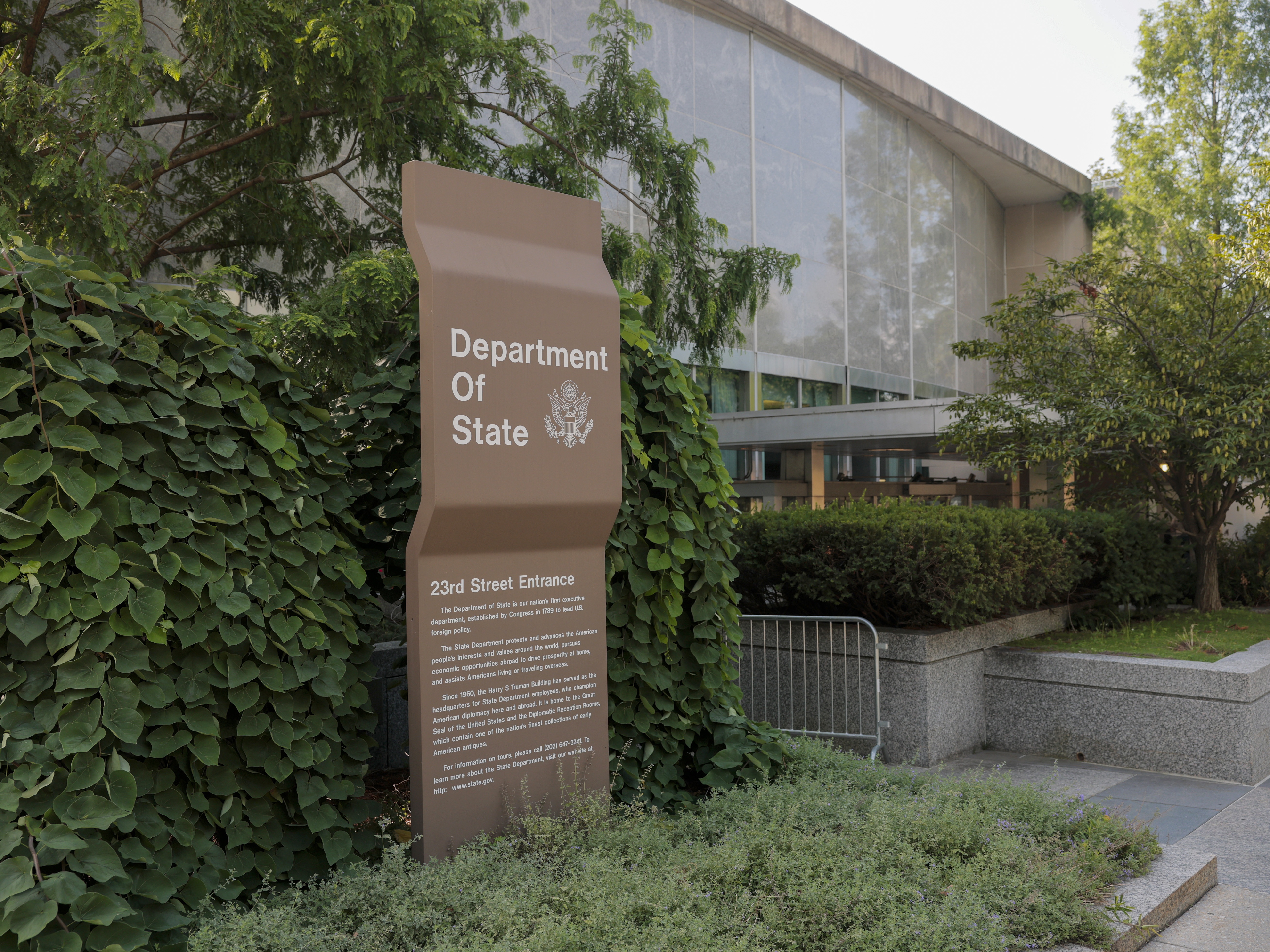 caption: A sign for the U.S. Department of State is seen on the outside of the Harry S. Truman Federal Building on on July 11, 2025 in Washington, DC.