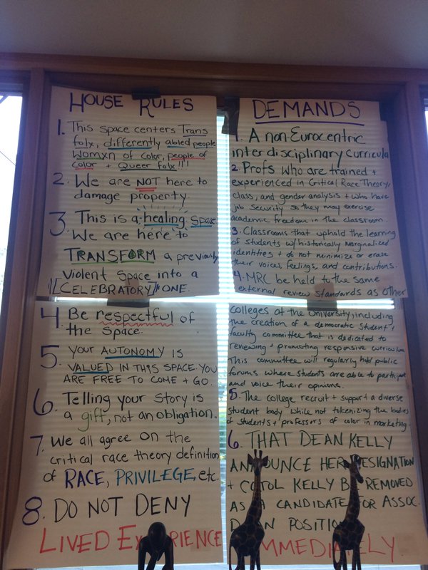 caption: Demands posted in a window of the occupied space at Matteo Ricci College.