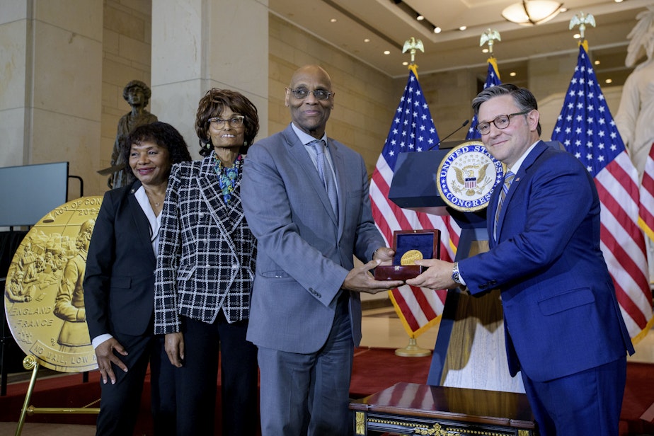 caption: House Speaker Mike Johnson, R-La., right, presents the Congressional Gold Medal to Stanley Earley III, son of Lt. Col. Charity Adams Earley, second from right, her daughter Judith Earley, second from left, and retired Army Col. Edna W. Cummings, during a ceremony honoring the Six Triple Eight, on Capitol Hill, Tuesday, April 29, 2025, in Washington, D.C.