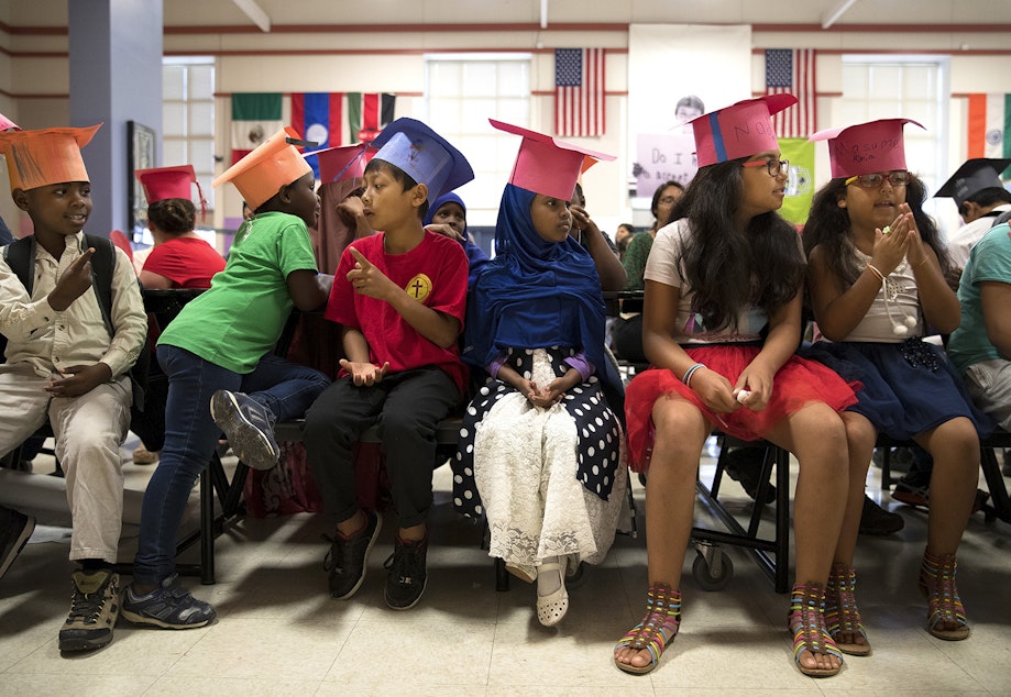 caption: Graduates of the International Rescue Committee summer school program, including Ikran Osman, 5, center, sit in the cafeteria before a graduation ceremony on Thursday, August 3, 2017, at Showalter Middle School in Tukwila.