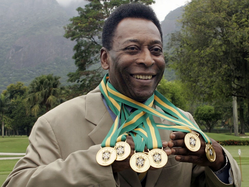 caption: Brazilian football legend Edson Arantes do Nascimento, better known as Pelé, poses with his six Brazil's champion medals in 2010. A Portuguese language dictionary has recognized his name as a synonym for greatness.