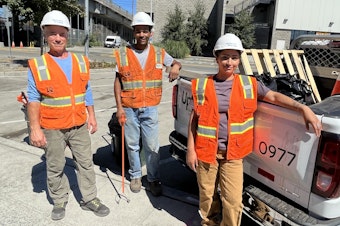 caption: Doug Copeland, Charles Hanks and Erika Lazcano are picking up litter in Ballard. They work for Uplift Northwest, which provides temporary labor for people experiencing poverty and homelessness.