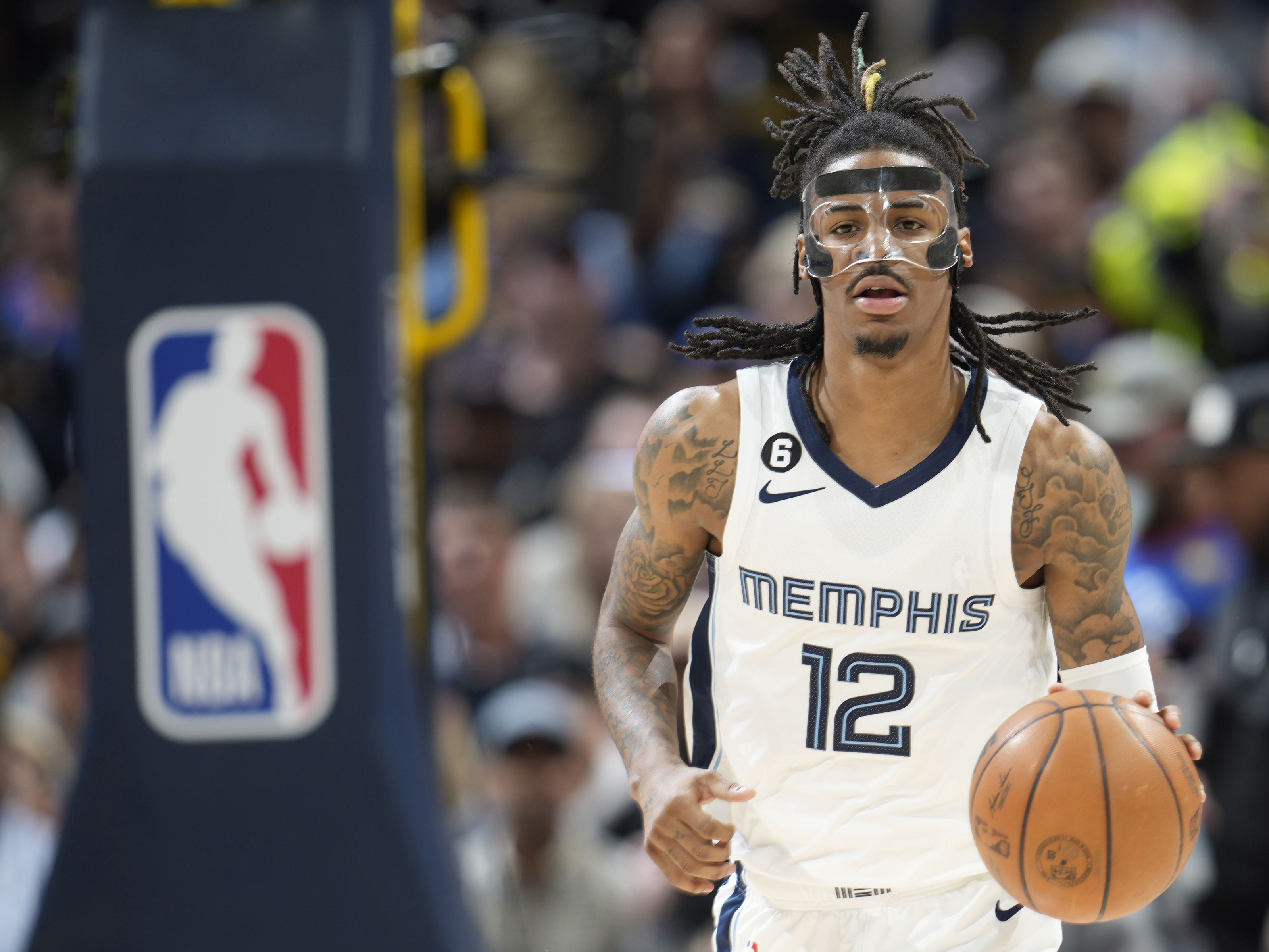 caption: The NBA has suspended Memphis Grizzlies guard Ja Morant eight games without pay, after determining that his holding a firearm at a club in suburban Denver earlier this month was "conduct detrimental to the league."