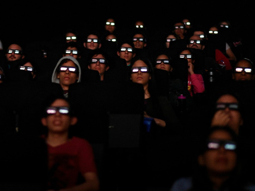 caption: Filmgoers watch a screening of Marvel Studios' <em>Avengers: Endgame</em> at a cinema in Caracas in April 2019. More than 50 workers at Marvel Studios in LA, New York and Atlanta have signed authorization cards to be represented by the International Alliance of Theatrical Stage Employees, or IATSE.