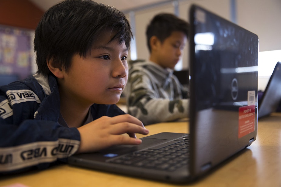 caption: Rafael Isla, a 7th-grade student in Janet Bautista's science class, completes an assignment about chemical reactions on a laptop on Thursday, March 28, 2019, at Asa Mercer Middle School in Seattle. 