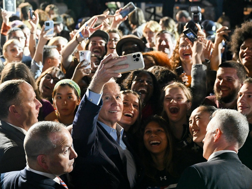 caption: President Biden takes a selfie with supporters during a rally in New York ahead of the 2022 midterm elections.