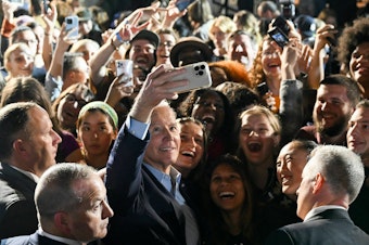 caption: President Biden takes a selfie with supporters during a rally in New York ahead of the 2022 midterm elections.
