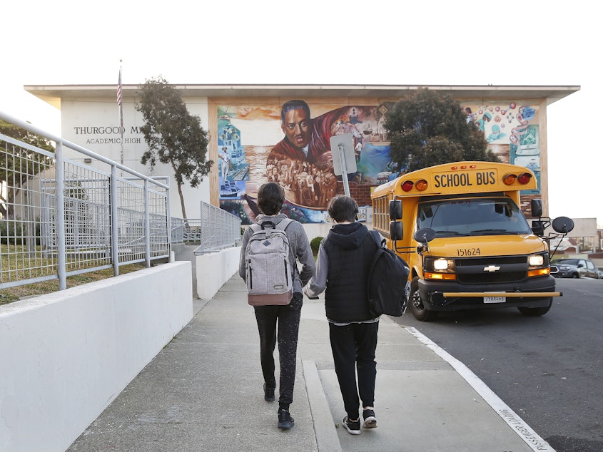 caption: Students head toward Thurgood Marshall Academic High School in San Francisco in March.