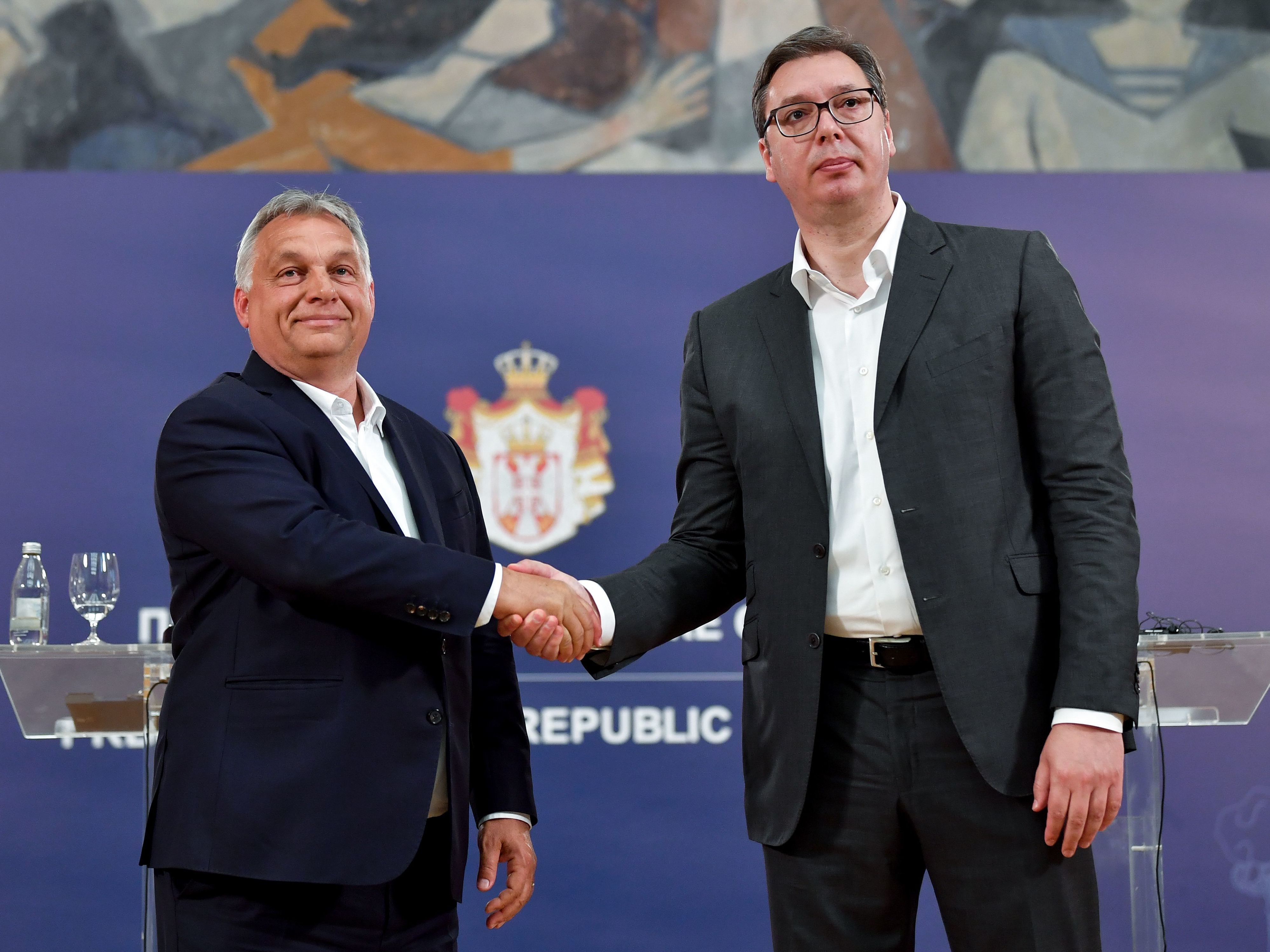 caption: Hungarian Prime Minister Viktor Orban (left) and Serbian President Aleksandar Vucic shake hands after a joint press conference in Belgrade in 2020. Both men won reelection over the weekend.